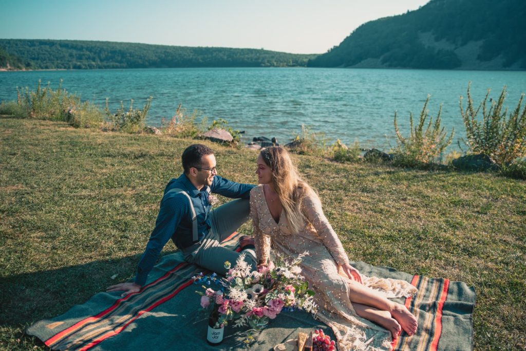A couple plans a picnic for their elopement by the lake
