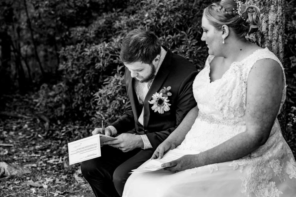 Following their Pennsylvania elopement ceremony, the couple fills out paperwork to make their marriage a legal one.