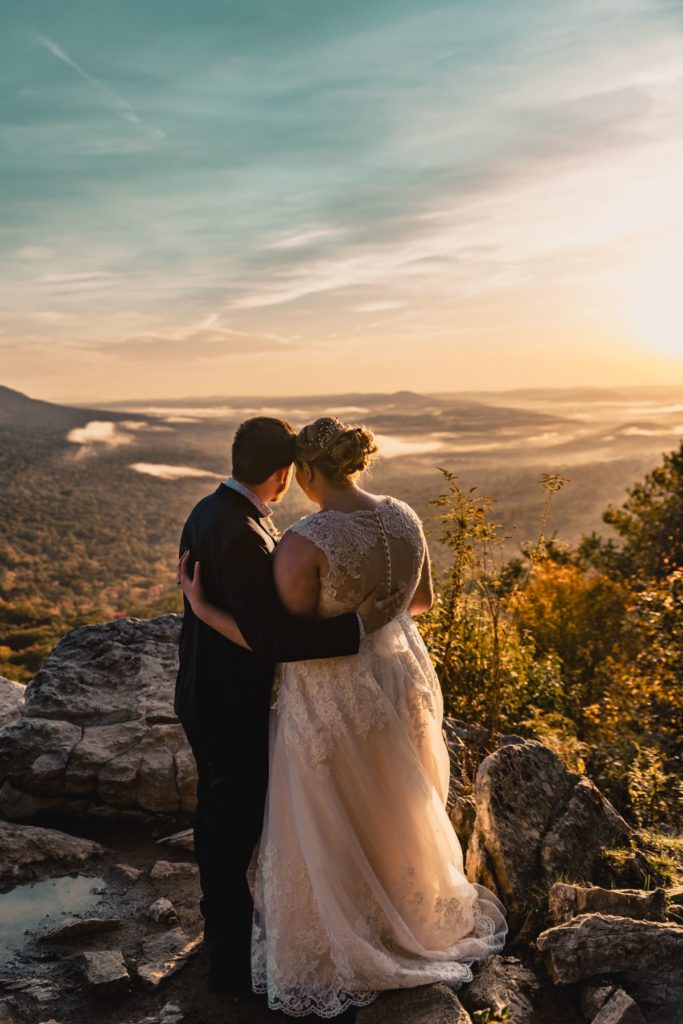 Bride and groom embrace after their first look at sunrise from the overlook on the mountain during their Pennsylvania hiking elopement.