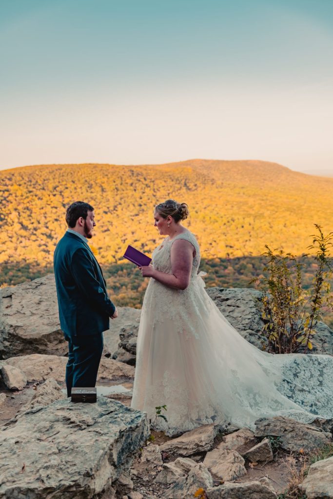 During their elopement ceremony, the bride reads her vows on an overlook in the mountains of Pennsylvania.